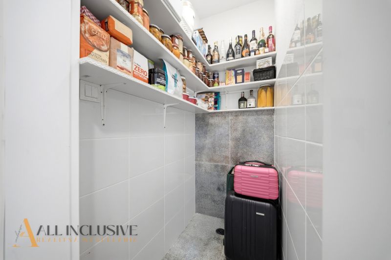 Pantry in a family house with shelves full of food and preserves.