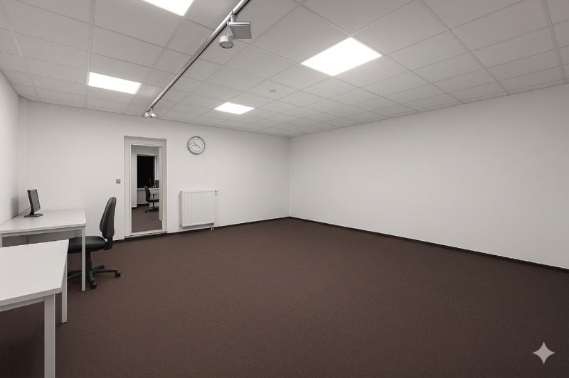 Spacious offices with white walls, brown carpet, and minimalist furnishings.
