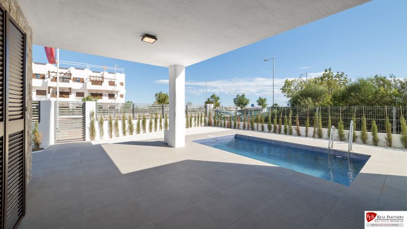 Terrace of a 2-bedroom apartment in Pulpí with a pool and a view.