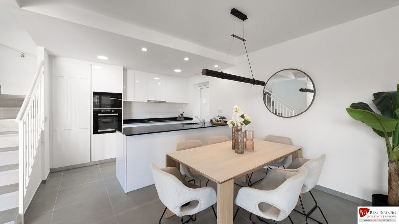 Dining room in a 2-room apartment with a spacious table and kitchen.