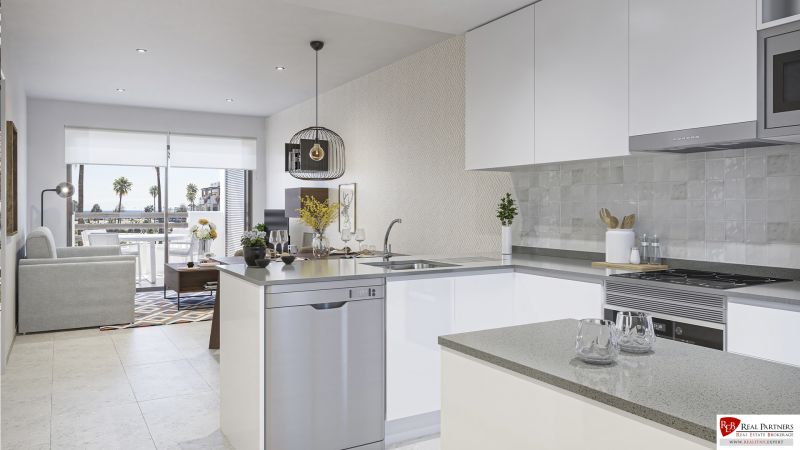 Interior of a holiday apartment with a modern kitchen and a view of the coastline.