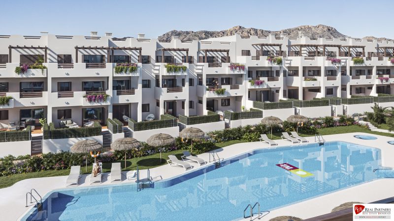 A holiday apartment in Pulpí with a pool, sunbeds, and umbrellas, surrounded by greenery.