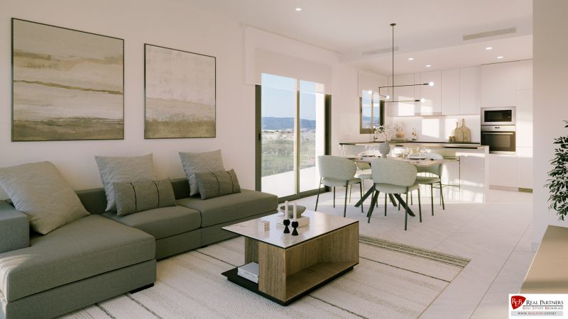 Bright living area of a holiday apartment with a sofa and dining table.