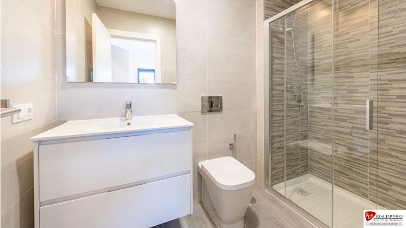 Bathroom in a holiday apartment with a large shower and an elegant sink.