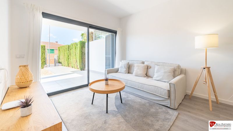 Recreational apartment with a comfortable sofa, table, and large window.