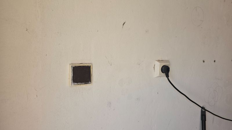 A wall with an electrical outlet in the garages on Jesenského Street in Zvolen.
