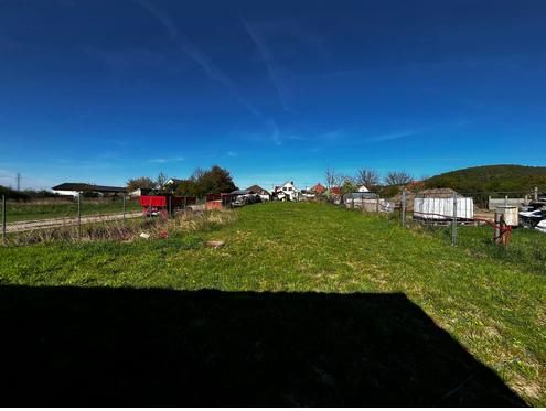 Lands - housing in Pernek, open green area, with fencing and a rural scene in the background.