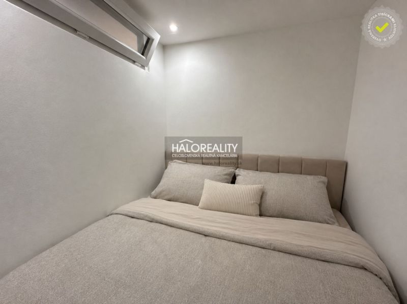 Guest room in a studio apartment with a minimalist design and a comfortable bed.