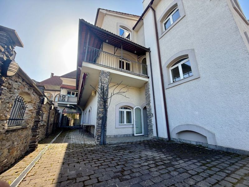 Mansion of peculiar real estate in Banská Bystrica with stone details and curb paving.