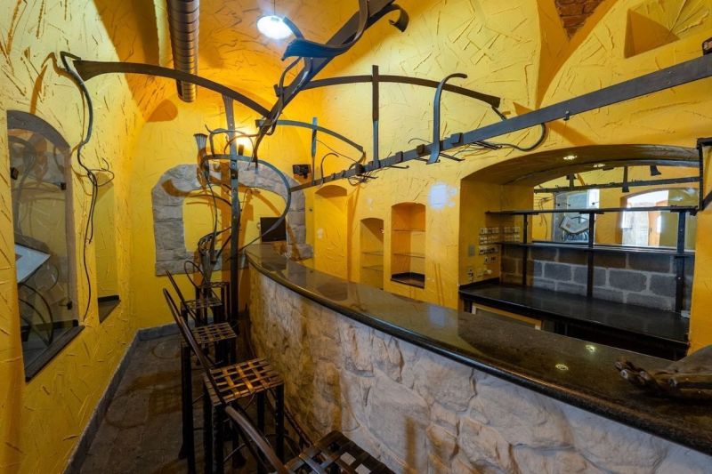 Interior with yellow walls, stone bar, and metal structures, Unique properties.
