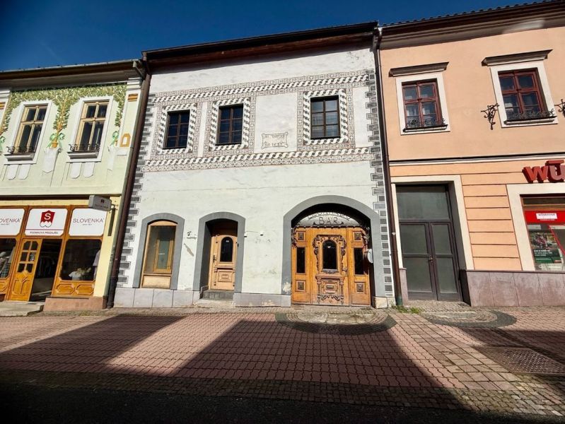 Historic buildings in Banská Bystrica, unique properties with decorative facades and shops.