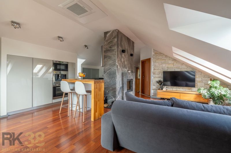 Interior of a 3-room apartment with a fireplace and flooring with a wooden decor.