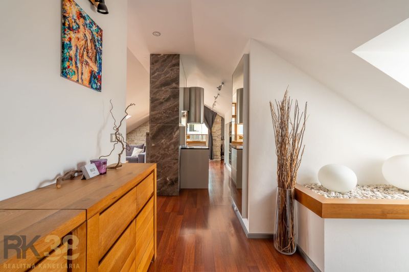 Interior of a 3-room apartment with a wooden decor floor and a wooden sideboard.
