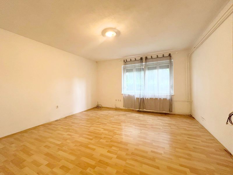Interior of a family house with a large window and a wooden decor floor.