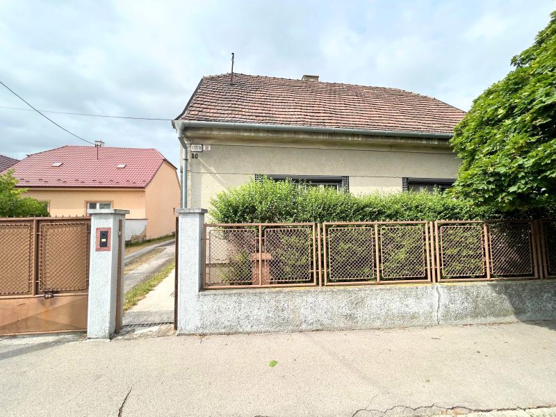 A family house on Krajinská Street in Bratislava - Podunajské Biskupice with a fence and a front garden.