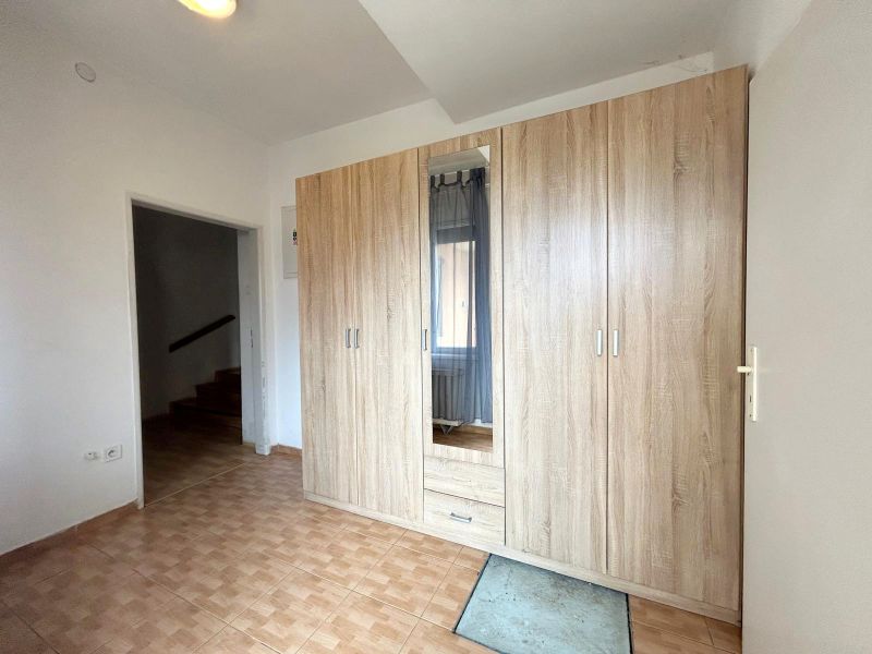 A cabinet with wood decor and tiles in a family house.