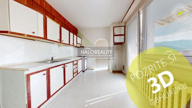 A kitchen in a 3-room apartment with older cabinets and balcony doors.