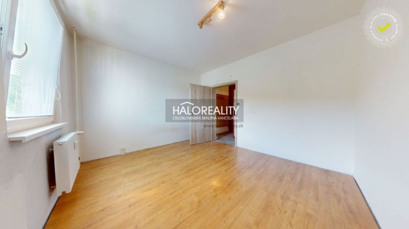 A room in a 3-room apartment with a wooden decor floor and white walls.