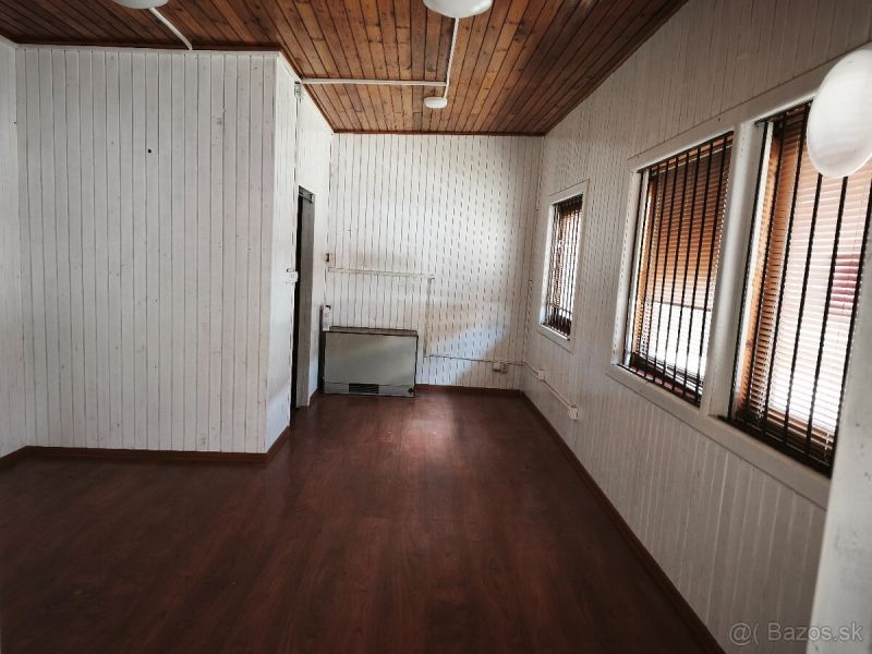 Commercial premises with a wood-patterned floor and walls with slat paneling.