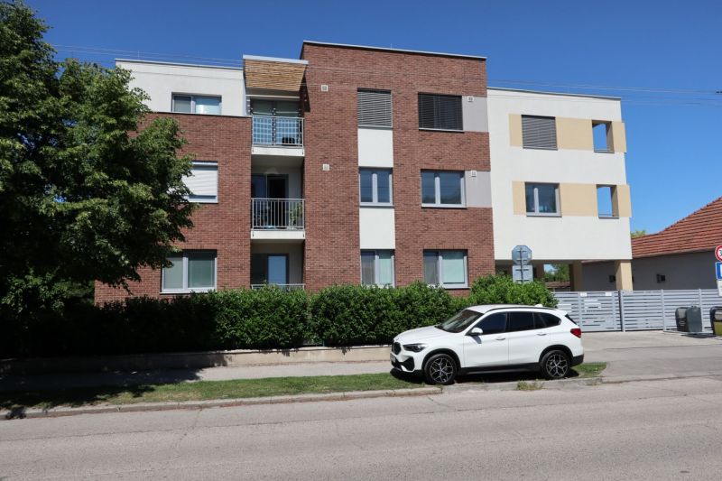 Apartment building on Štefánikova Street in Dunajská Streda with parking and greenery.
