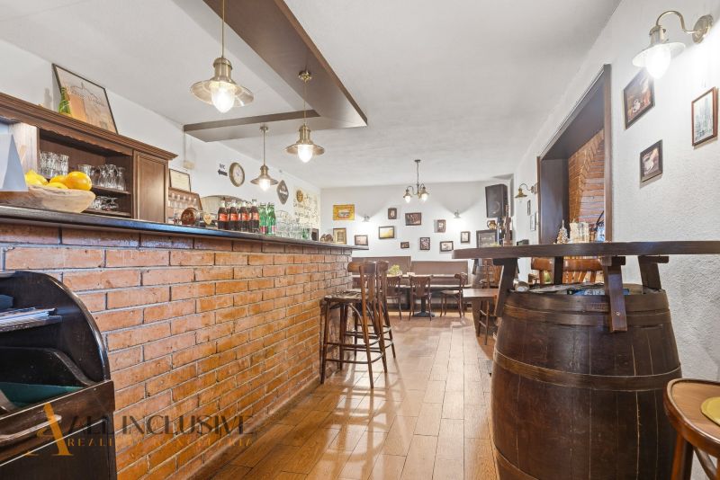 Brick bar and stools in a gastro space with a wooden decor floor.