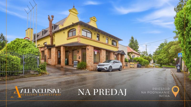 Street with a building, Gastro premises for sale in Nitra, lined with greenery and parking lot.