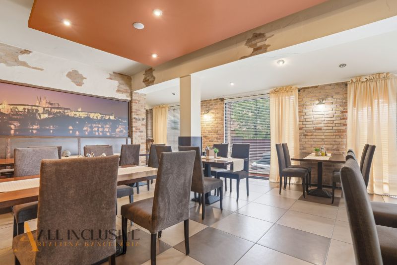 A restaurant space with brick walls and gray chairs, suitable for gastronomy businesses.