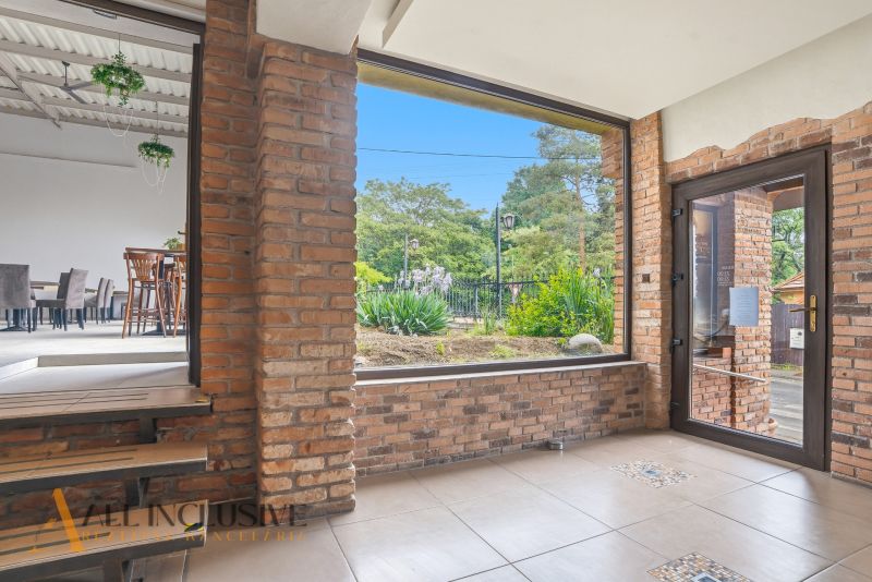 Interior with brick walls and a view of the outside greenery in dining spaces.