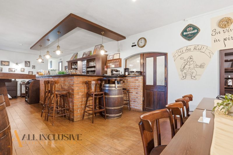 Interior of gastro spaces with a brick bar and flooring with a wood decor.
