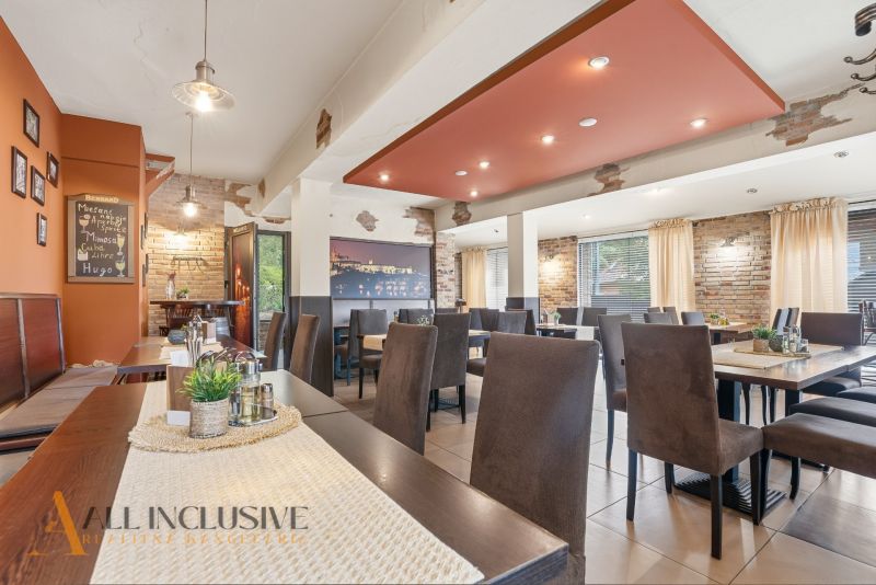 A restaurant with brick walls, a wooden decor floor, and cozy seating.
