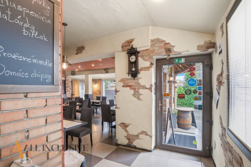 Interior of a gastro space with brick walls and a menu board.