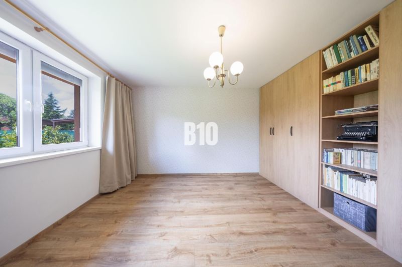 A family house with a wooden decor floor and a built-in bookshelf.