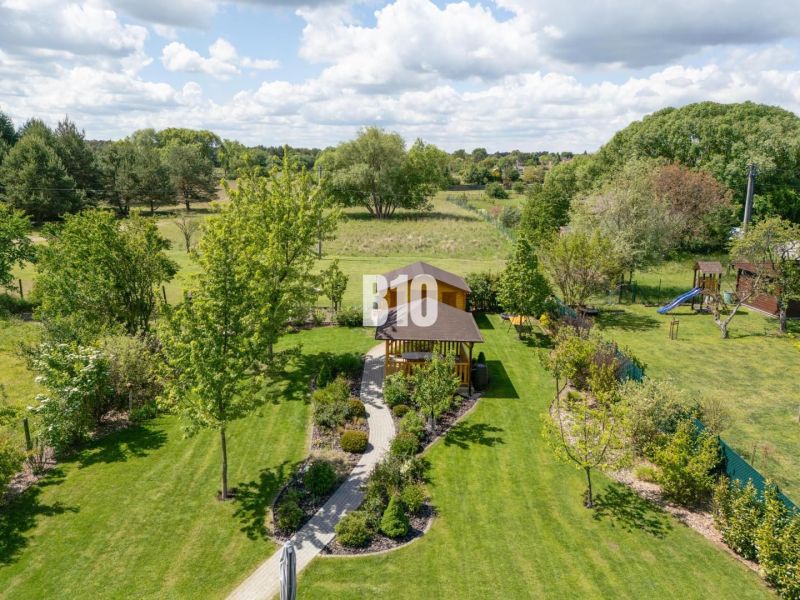 A garden at a family house in Bílkové Humence with a gazebo in a landscaped environment.