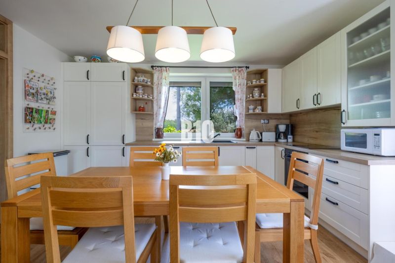 A kitchen in a family house with wooden furniture and decorative accessories.