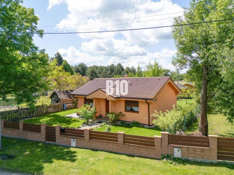 A family house in Bílkove Humence with a landscaped garden and terracotta facade.