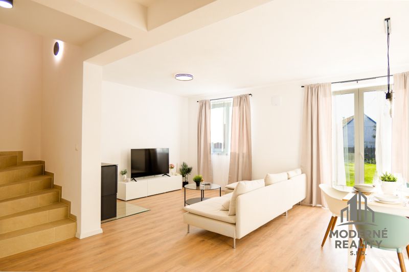 Bright living room of a family house with wood-decor flooring and comfortable seating.