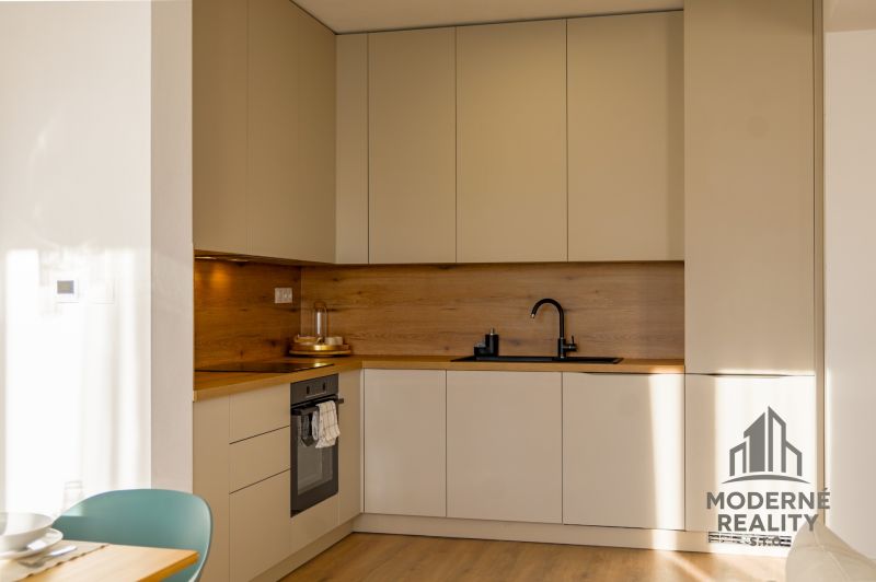 A kitchen in a family house with a wooden decor floor and minimalist design.