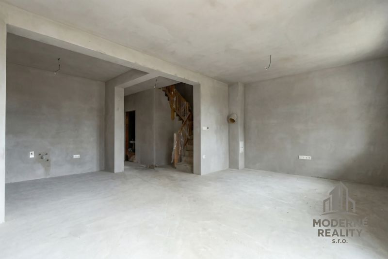 A raw interior in a family house with a staircase and preparation for electrical installation.