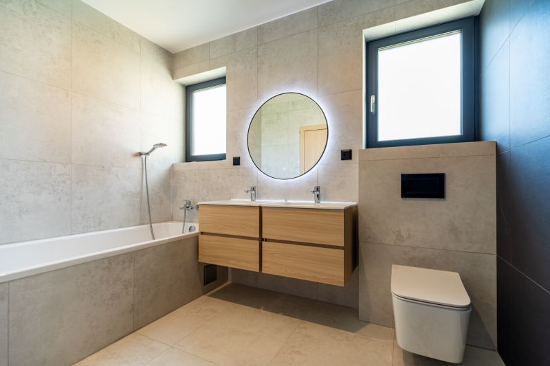 A bathroom in a family house with a bathtub, toilet, mirror, and two windows.