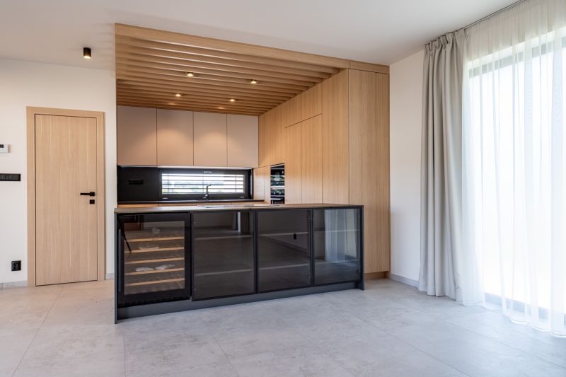 A kitchen with wooden decor, a glass wine cabinet, and a large window in a family house.