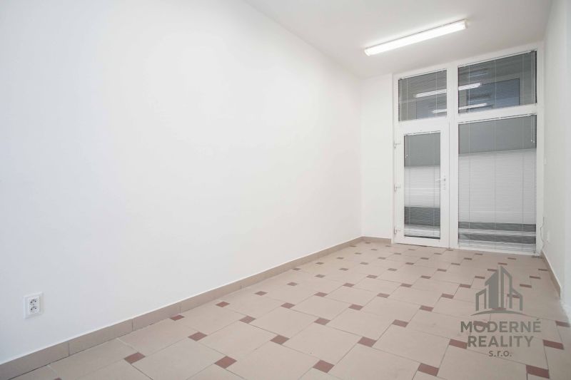Interior of an office with white walls and tiles, ideal for work.