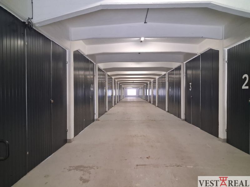 A long corridor with garage boxes in warehouses and halls.