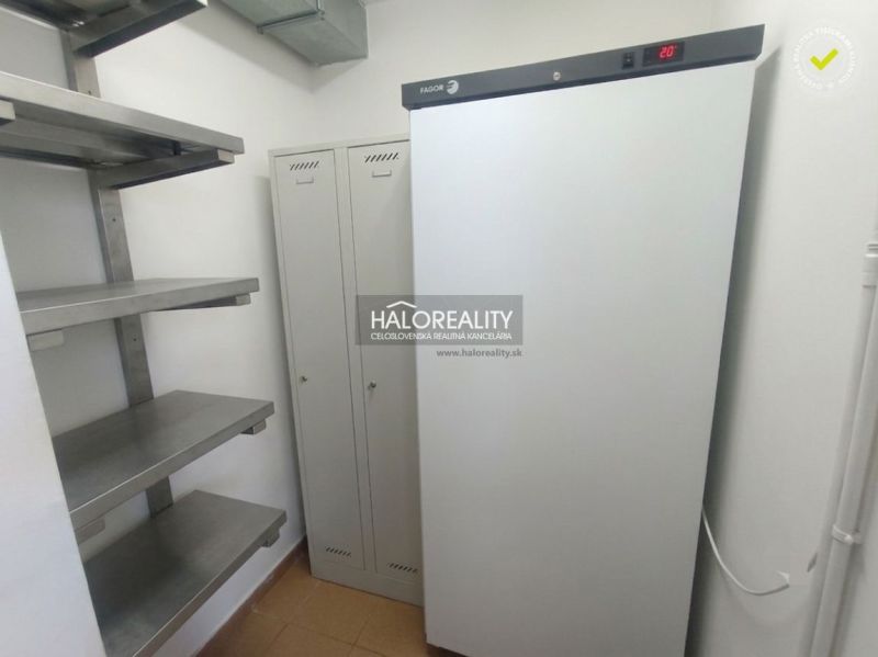 Storage space with metal shelves and a cabinet, equipped with a refrigerator.
