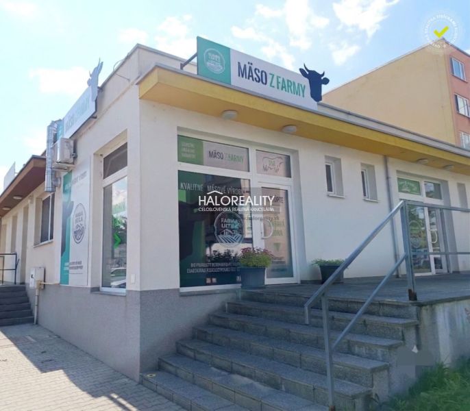Commercial premises in Žiar nad Hronom with advertisements for farm meat and an entrance staircase.