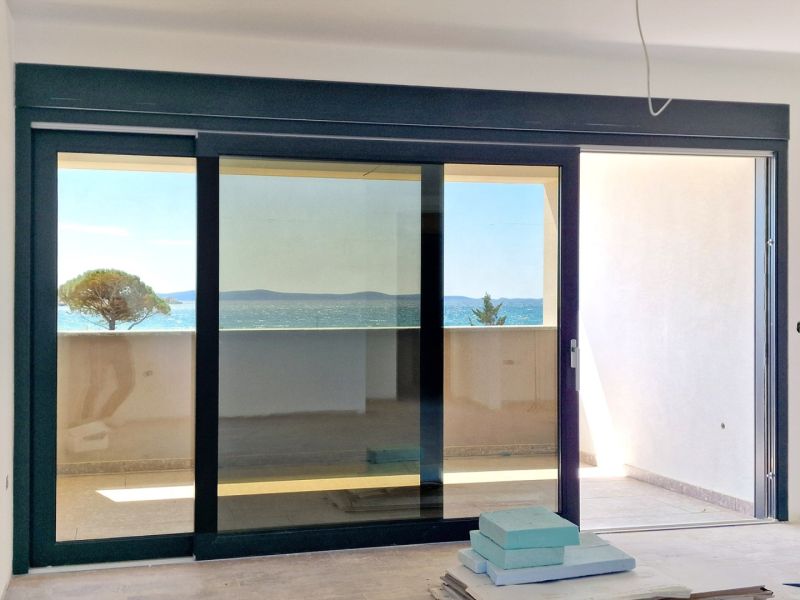 3-bedroom apartment with a terrace and sea view, wooden decor flooring.