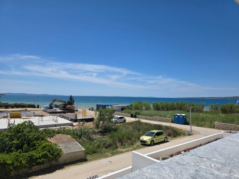 A seaside scene with a view of the calm blue waters in the town of Privlaka.