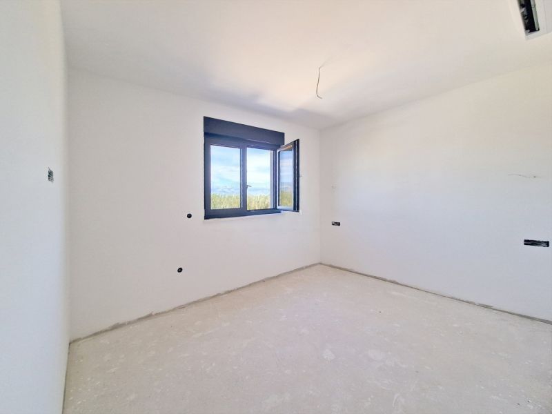 An empty room with an open window in a three-room apartment.
