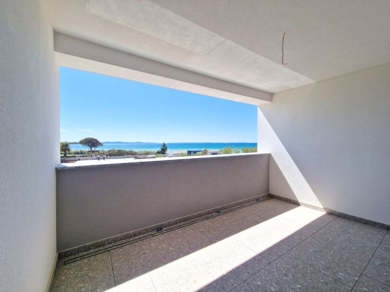 A view from the balcony of a 3-room apartment to the coast in Privlaka.