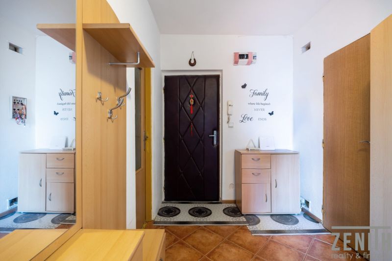 Entrance hall in a 3-room apartment with wooden decor and furniture.