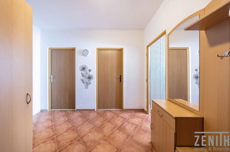 Entrance hallway in a 3-room apartment with practical furniture and wall decoration.